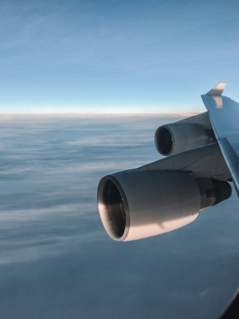 Flight attendant quotes: Boeing 747 airplane wing and engines flying over the ocean