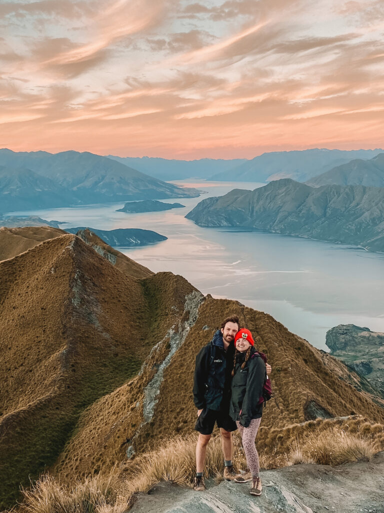 Niki and Ben on top of Roys Peak at sunset, Wanaka, South Island New Zealand