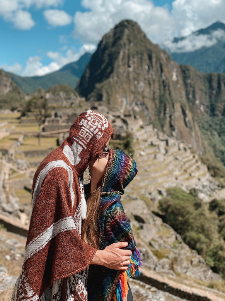 Couple travel quotes for Instagram: Niki and Ben kissing at Machu Picchu, Cusco Peru